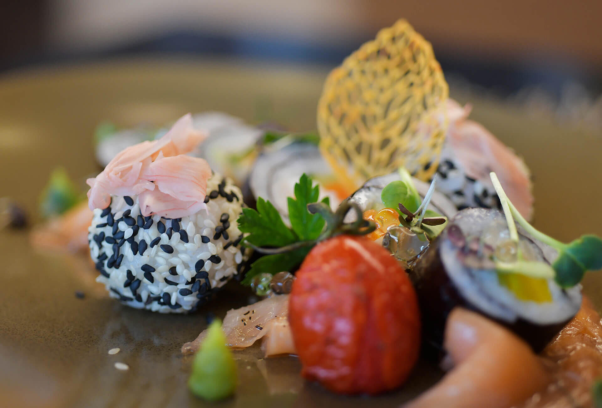 Vorspeise mit Fisch, Gemüse und Kräutern kunstvoll angerichtet.