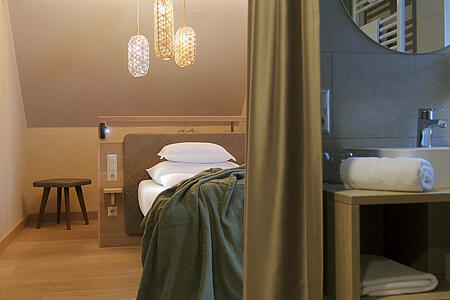 Großzügiges Doppelzimmer mit Dachschräge und indirekter Beleuchtung